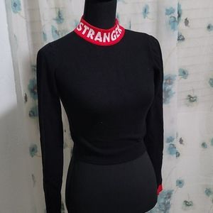 Black/red/white cropped sweater wording stranger